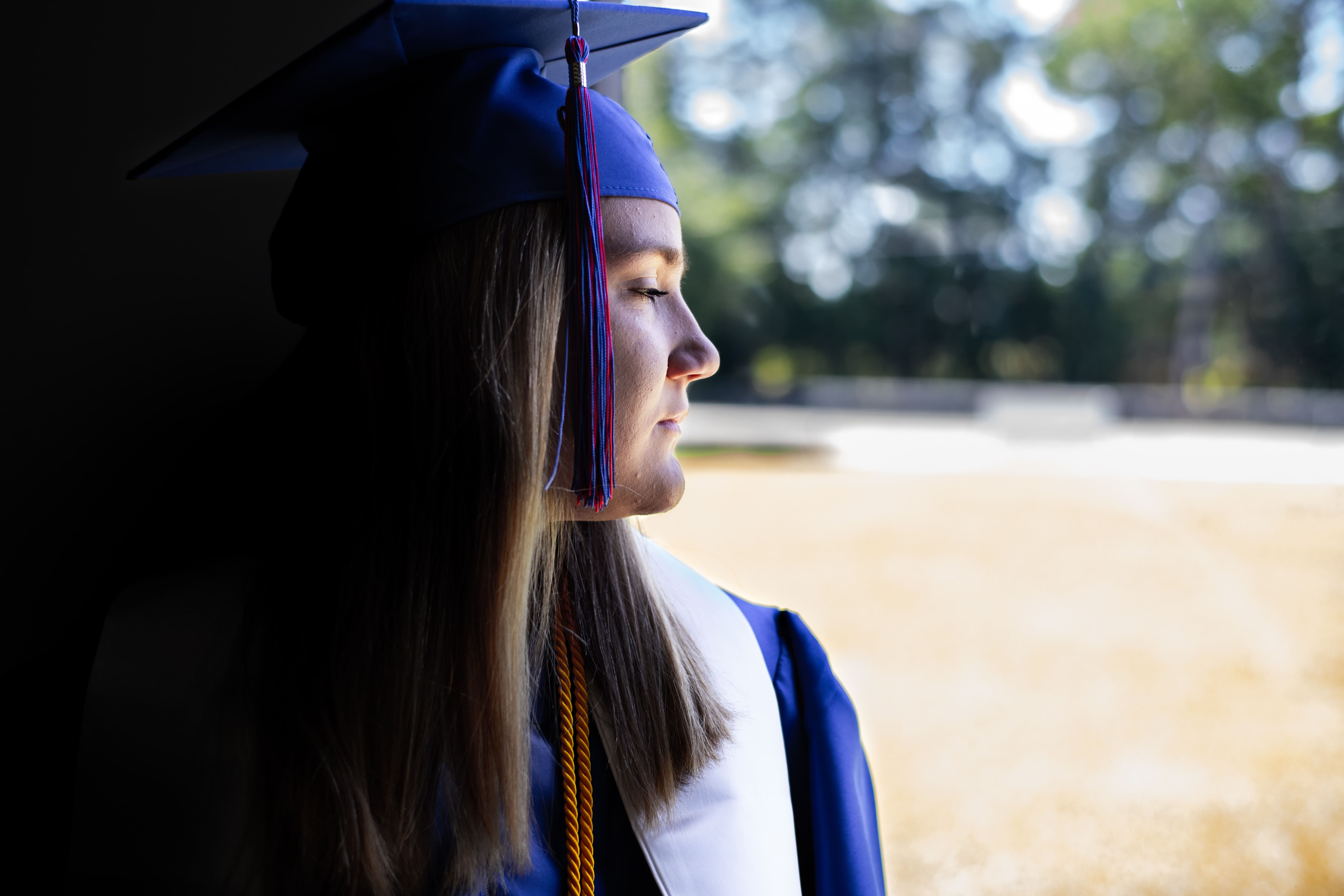 girl-wearing-blue-graduation-gown-and-cap-min